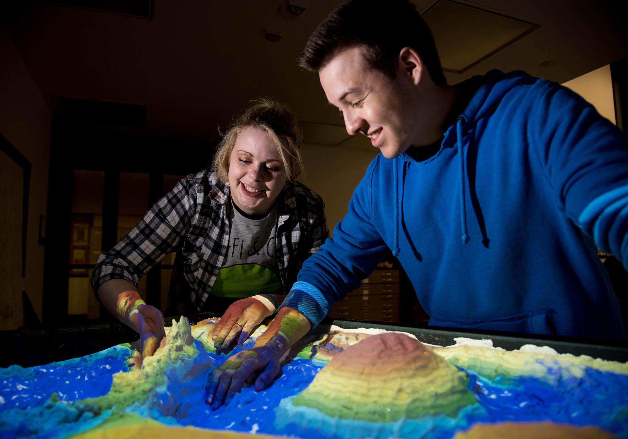 Students Using Interactive Glowing Map